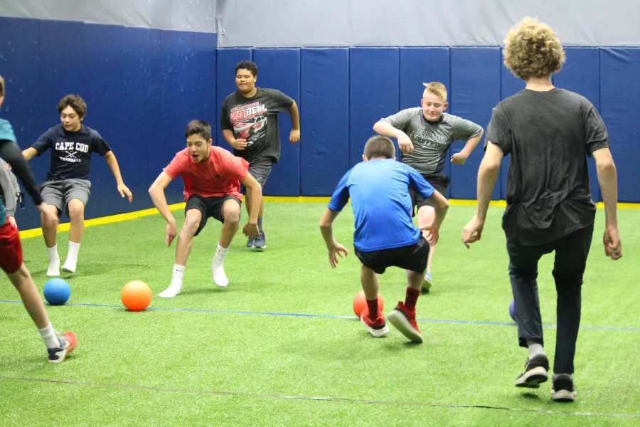Kids playing dodgeball on the turf
