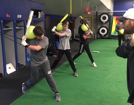 Coach McArthur working with hitters during an Explosive Hitting drill